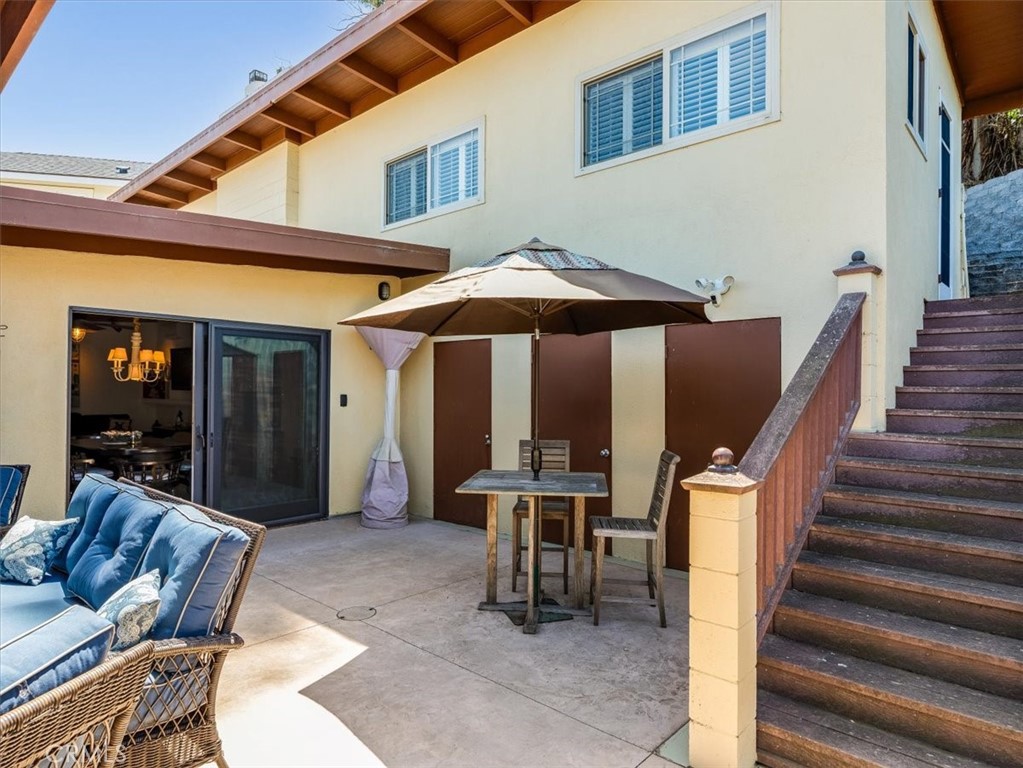 430 Olive Street Morro Bay, CA 93442 - Photo 55 of 68 a view of a patio with a table and chairs under an umbrella