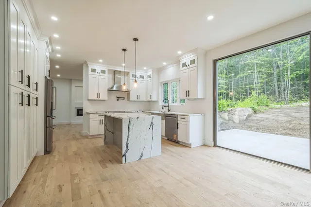 a large white kitchen with a large window