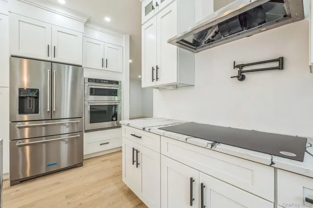 a kitchen with appliances cabinets and wooden floor