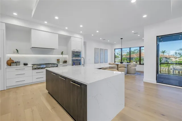 a bathroom with a sink a toilet and a large mirror