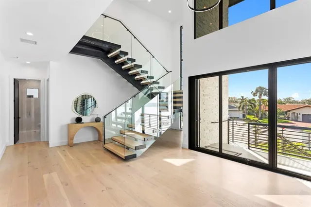 a large kitchen with kitchen island a sink a counter and chairs