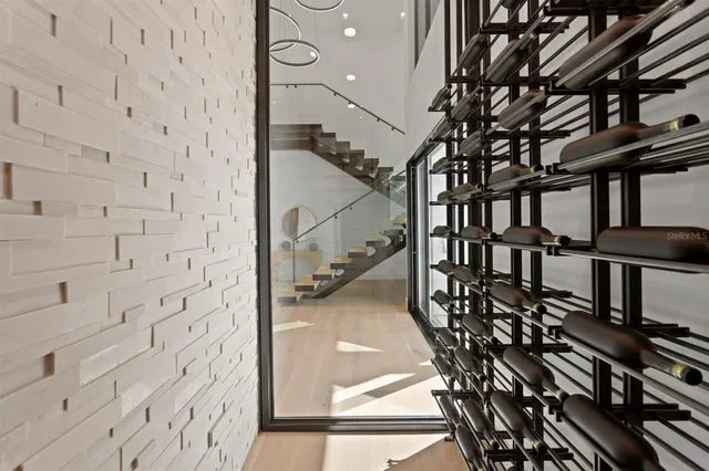a dining room with furniture a chandelier and wooden floor