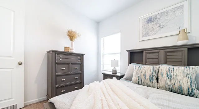 a bedroom with a bed and a dresser