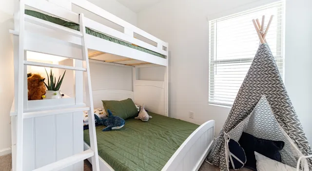 a bedroom with a bed and a window