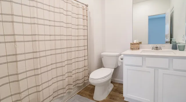a bathroom with a toilet sink and mirror