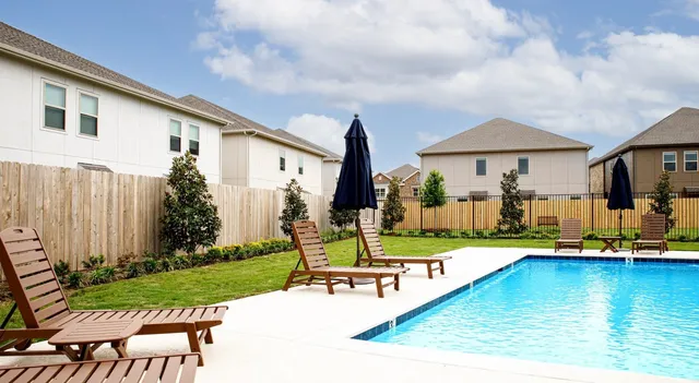 swimming pool with outdoor seating and yard