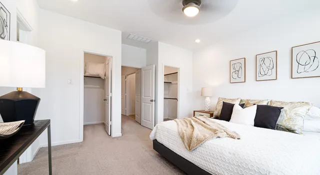 a bedroom with bed and night stand