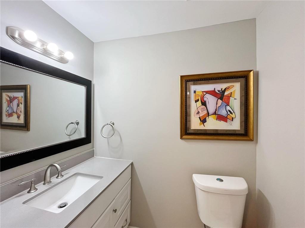 6520 Roswell Road, Unit 3 Atlanta, GA 30328 - Photo 12 of 47 a bathroom with a toilet a sink and mirror