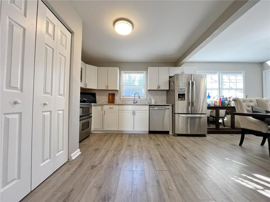 6520 Roswell Road, Unit 3 Atlanta, GA 30328 - Photo 17 of 47 a kitchen with white cabinets and white appliances