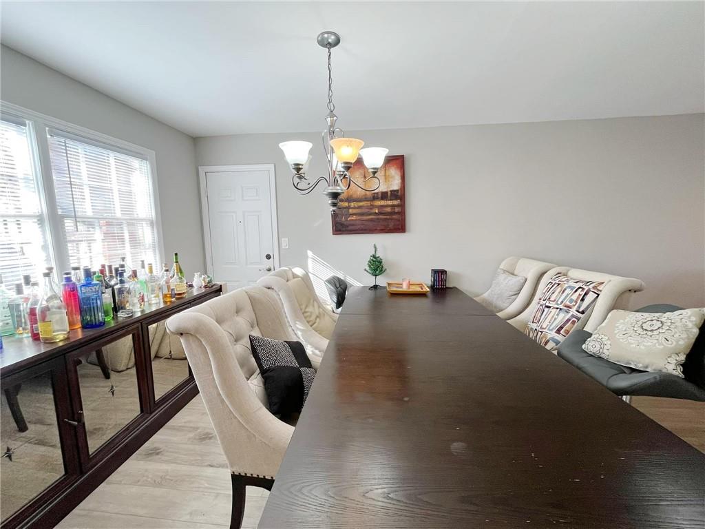 6520 Roswell Road, Unit 3 Atlanta, GA 30328 - Photo 21 of 47 a living room with furniture and a chandelier