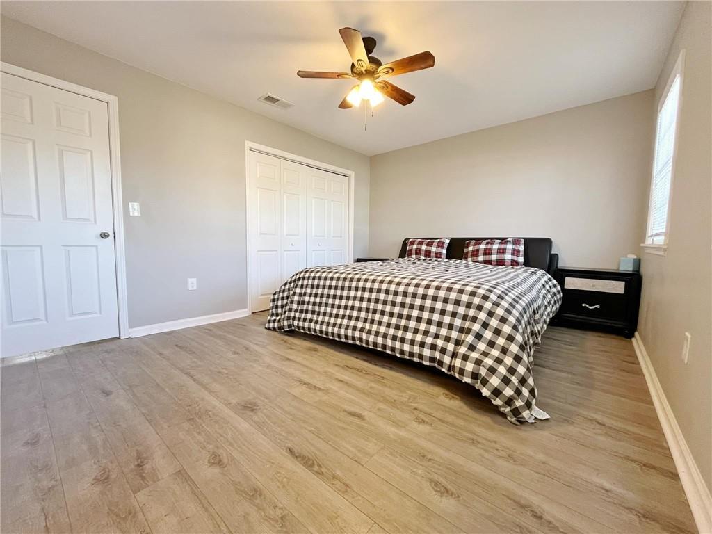 6520 Roswell Road, Unit 3 Atlanta, GA 30328 - Photo 25 of 47 a bedroom with a bed and a ceiling fan with wooden floor