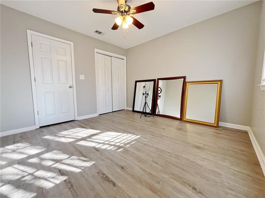 6520 Roswell Road, Unit 3 Atlanta, GA 30328 - Photo 30 of 47 a view of an empty room with window and wooden floor