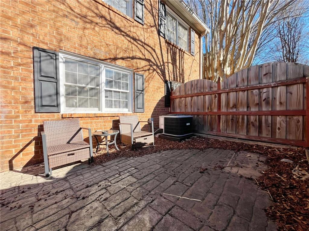 6520 Roswell Road, Unit 3 Atlanta, GA 30328 - Photo 37 of 47 a backyard of a house with barbeque oven table and chairs