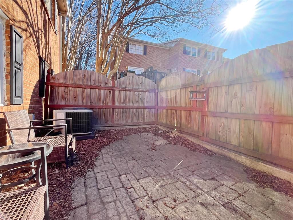 6520 Roswell Road, Unit 3 Atlanta, GA 30328 - Photo 38 of 47 a backyard of a house with chairs and wooden fence