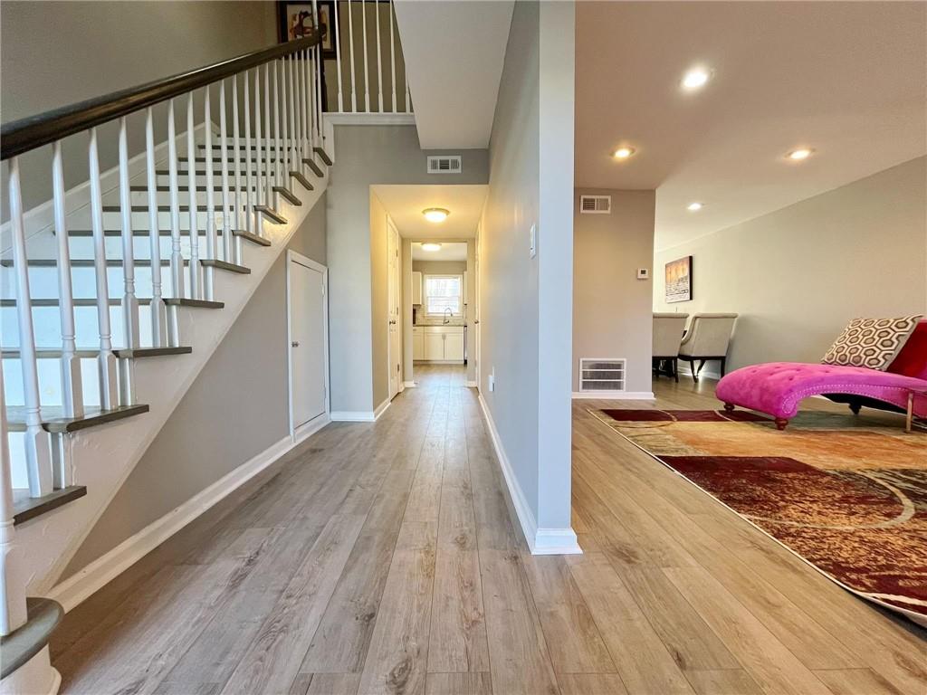 6520 Roswell Road, Unit 3 Atlanta, GA 30328 - Photo 5 of 47 a view of a hallway with wooden floor and staircase