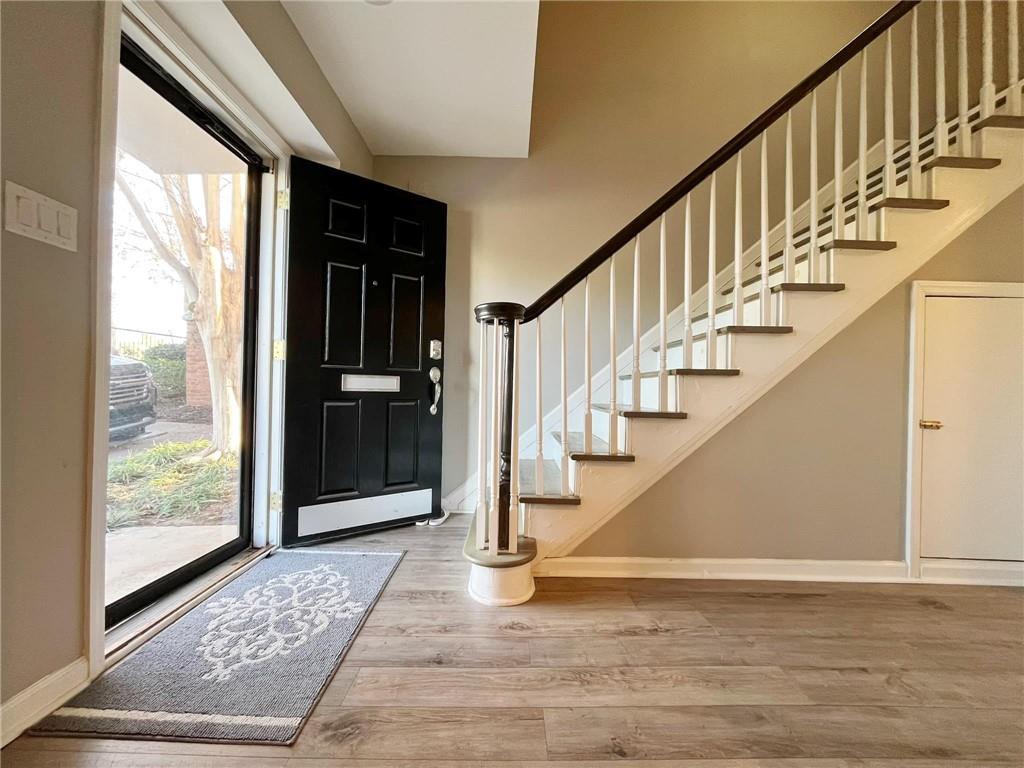 6520 Roswell Road, Unit 3 Atlanta, GA 30328 - Photo 6 of 47 a view of staircase with wooden floor and a rug