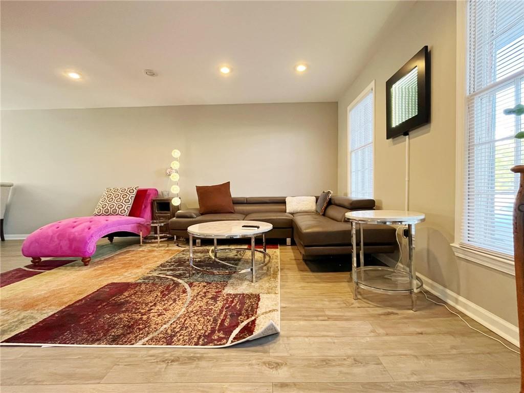 6520 Roswell Road, Unit 3 Atlanta, GA 30328 - Photo 8 of 47 a living room with furniture a rug and a window