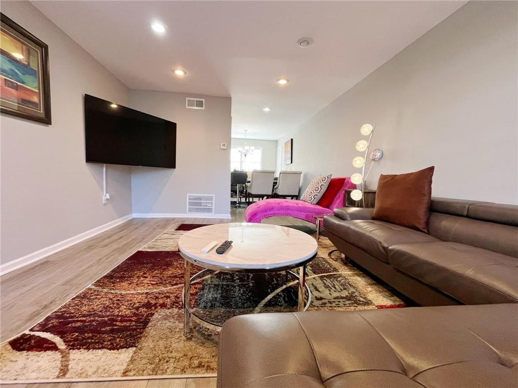 6520 Roswell Road, Unit 3 Atlanta, GA 30328 - Photo 9 of 47 a living room with furniture and a flat screen tv