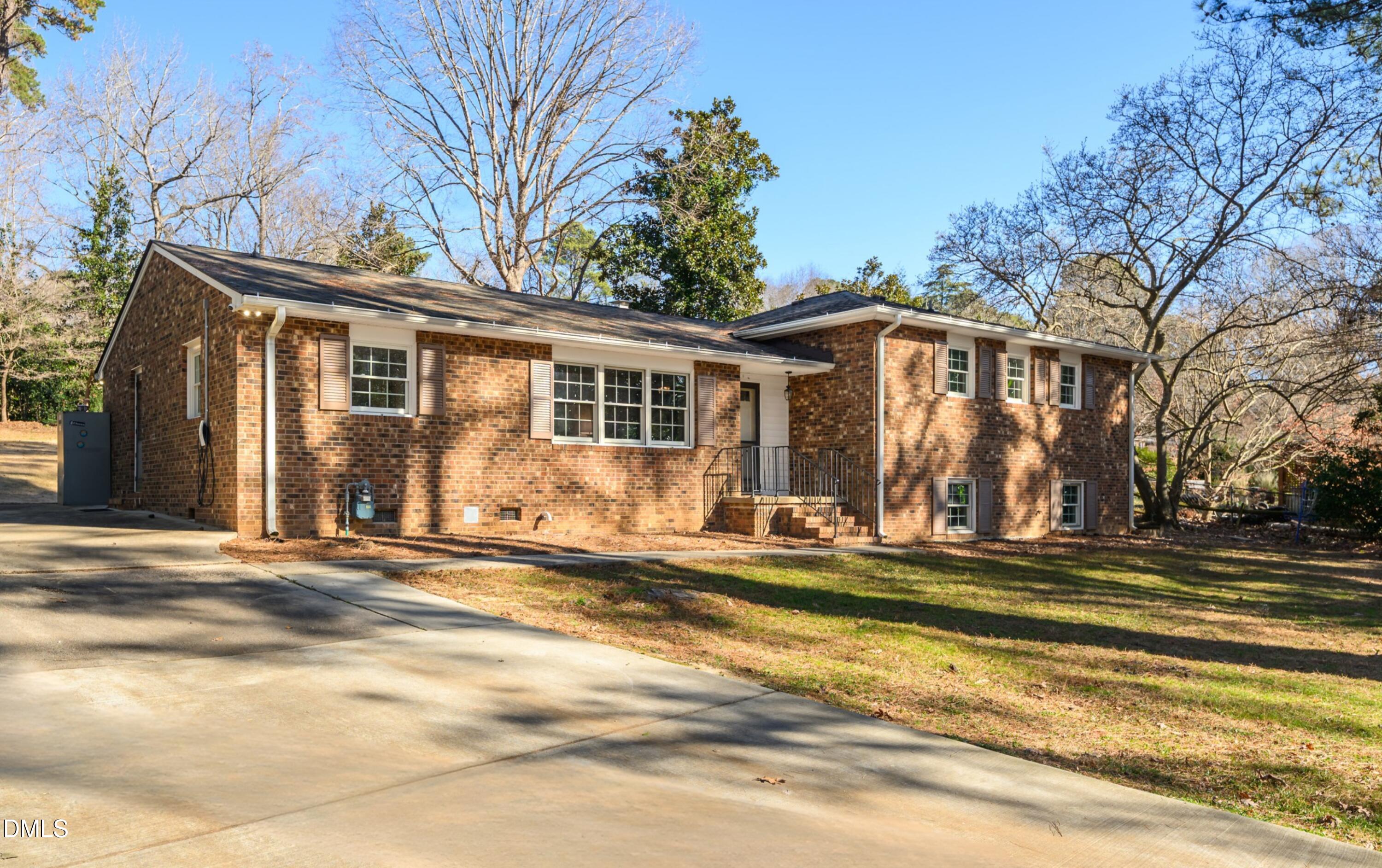 3726 Swift Drive Raleigh, NC 27606 - Photo 1 of 40 a view of a house with a large windows and large trees