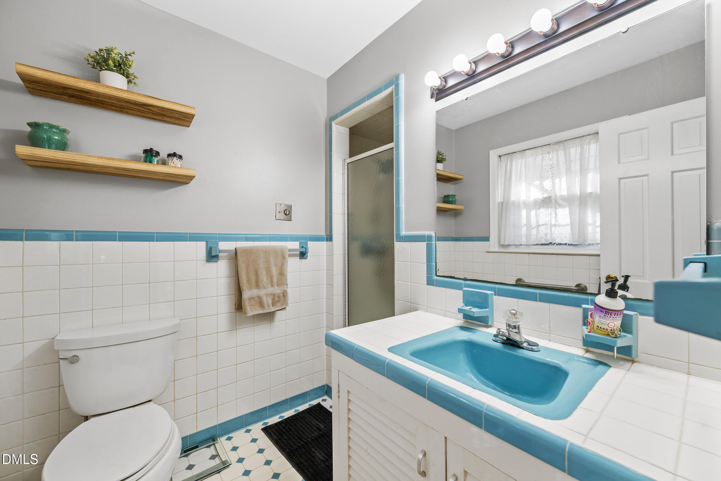3726 Swift Drive Raleigh, NC 27606 - Photo 20 of 40 a bathroom with a sink toilet and mirror