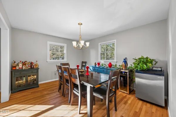 a view of a dining room with furniture and wooden floor