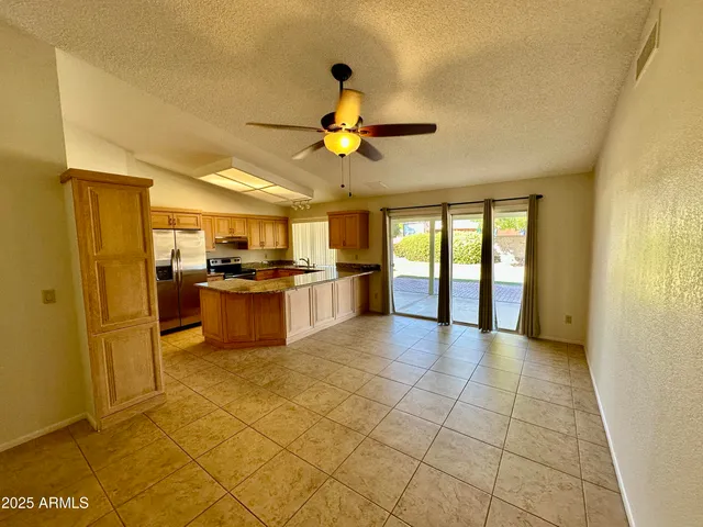 a view of a kitchen with an empty space and a window