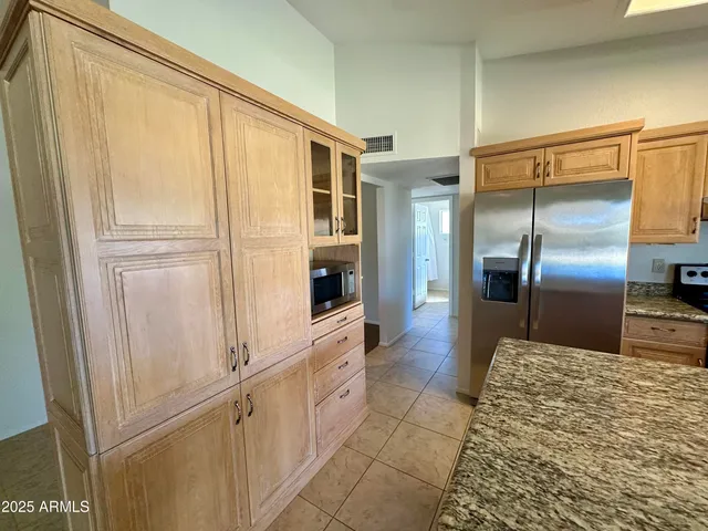 a kitchen with stainless steel appliances a refrigerator and a sink