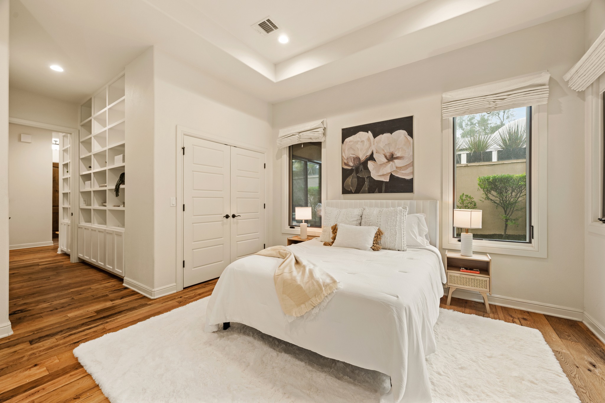 3907 Bailey Lane Austin, TX 78756 - Photo 17 of 40 The primary suite enjoys calming, neutral toned walls, beautiful views from the windows, and light fixtures that put off soft illumination