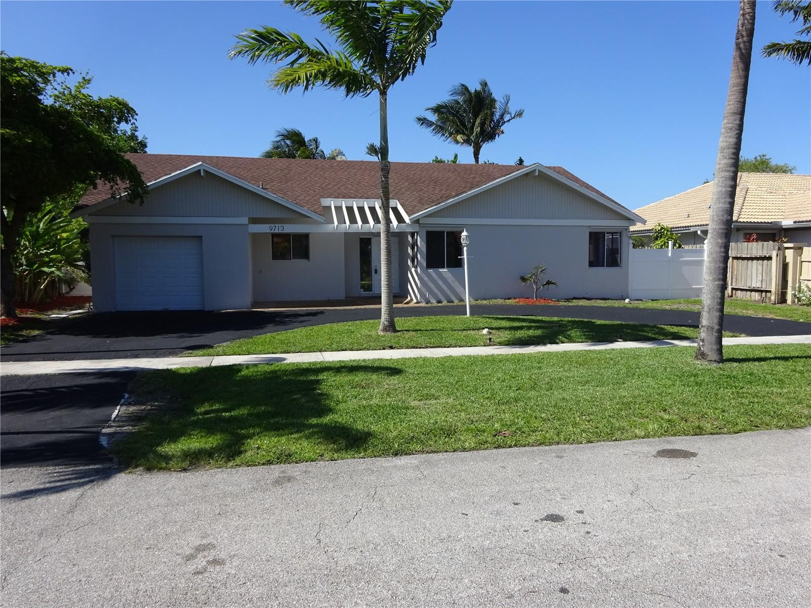 9713 Carousel Circle West Boca Raton, FL 33434 - Photo 3 of 59 a front view of house with yard and green space