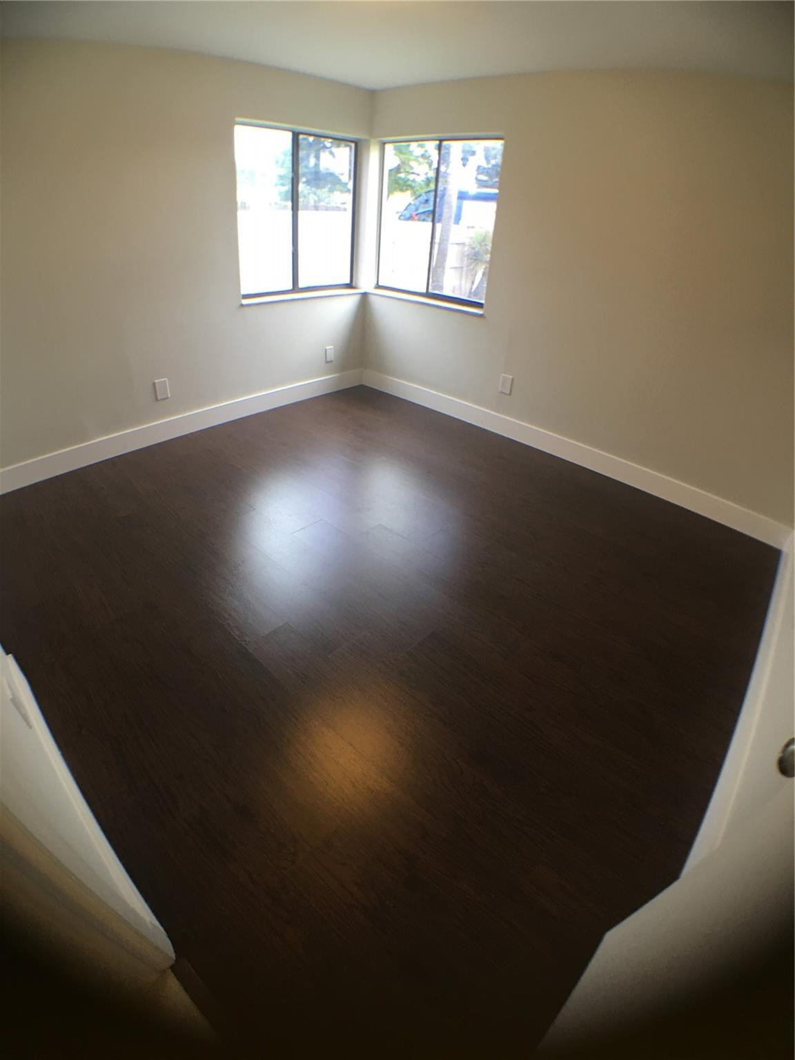 9713 Carousel Circle West Boca Raton, FL 33434 - Photo 39 of 59 an empty room with wooden floor and windows