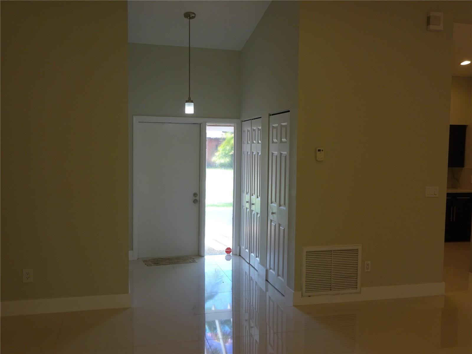 9713 Carousel Circle West Boca Raton, FL 33434 - Photo 6 of 59 a view of a hallway with wooden floor and a cabinet