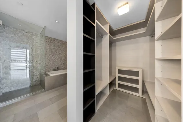 a view of closet area with empty racks