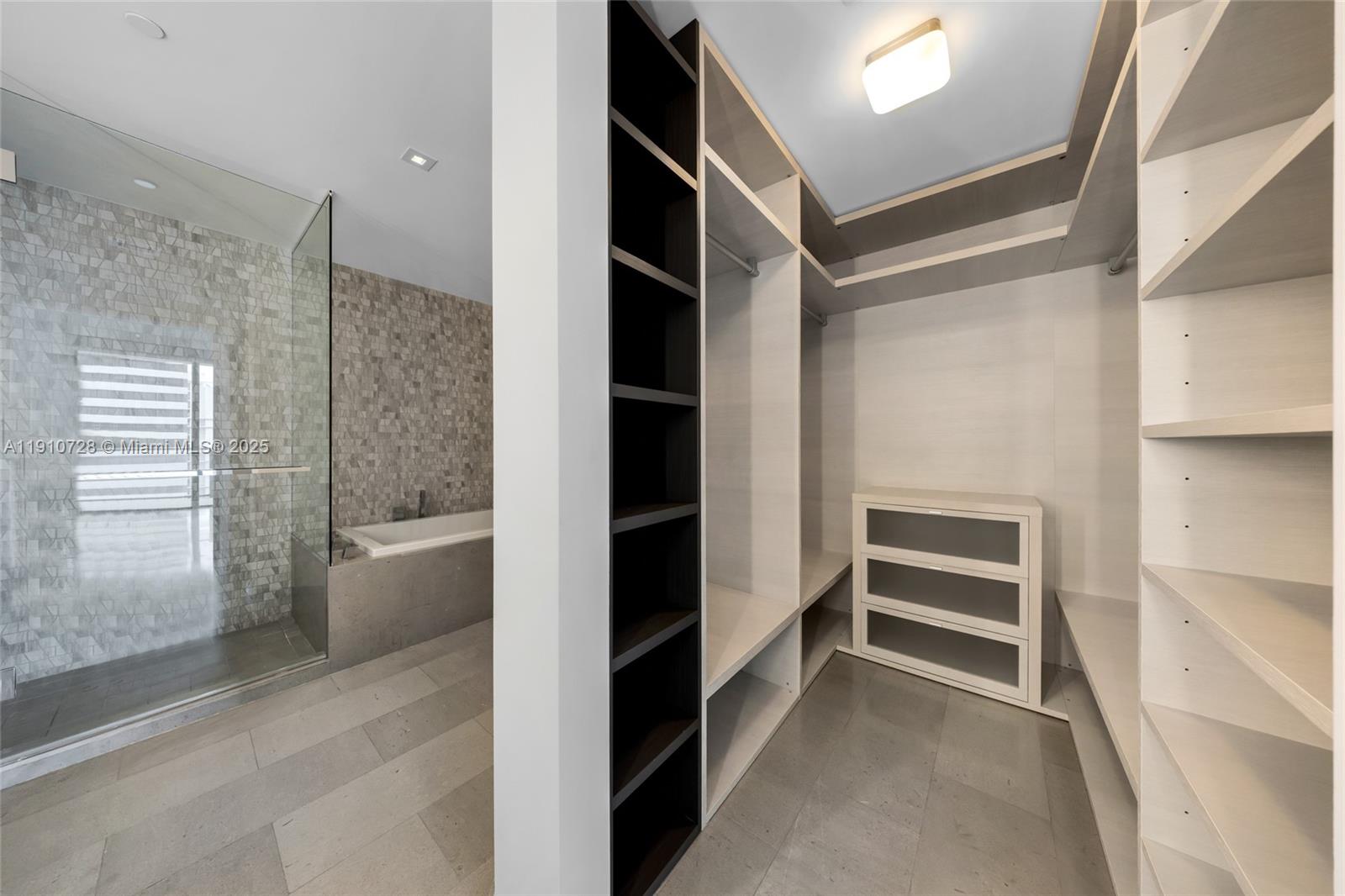 88 Southwest 7th Street, Unit 1004 Miami, FL 33130 - Photo 12 of 40 a view of closet area with empty racks