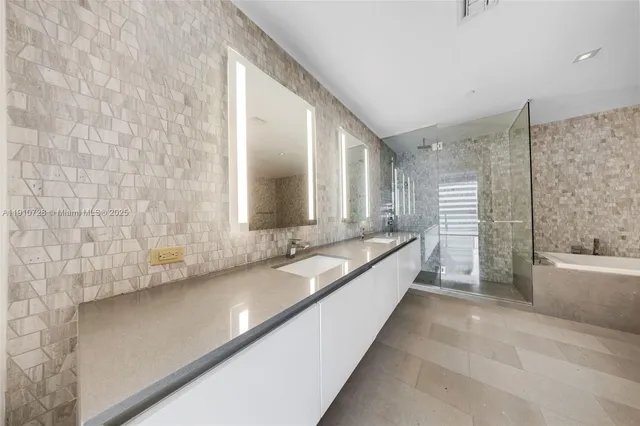 a large bathroom with a bathtub and a sink