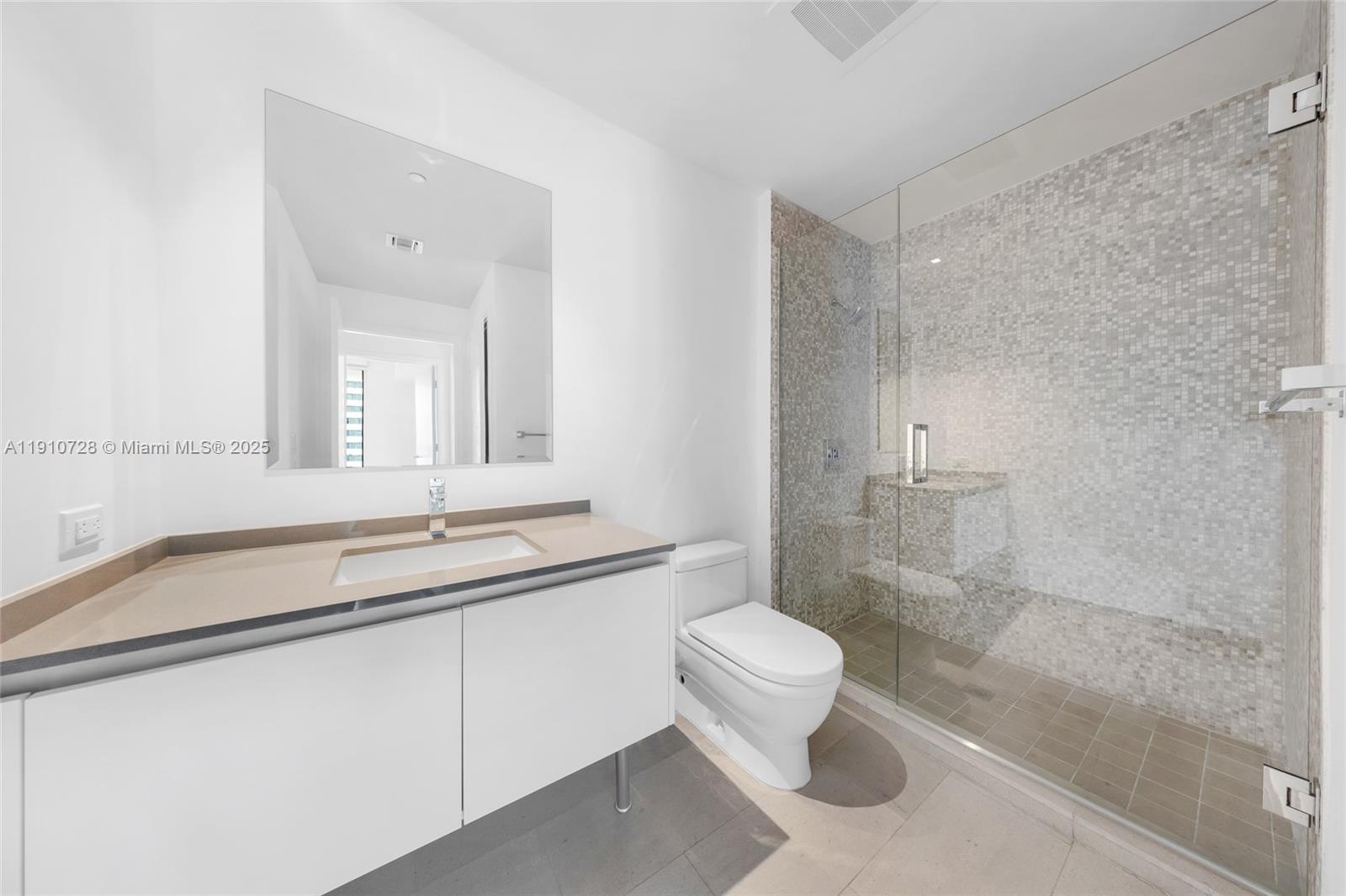 88 Southwest 7th Street, Unit 1004 Miami, FL 33130 - Photo 22 of 40 a bathroom with a sink and mirror with toilet