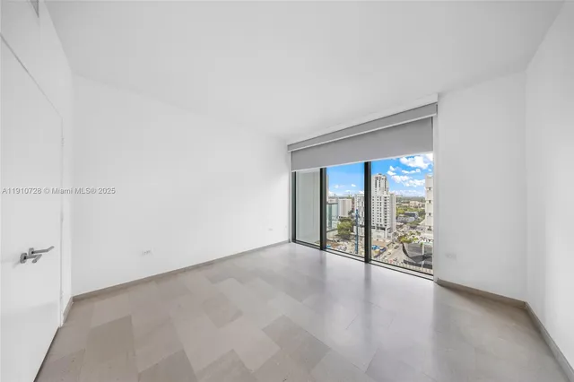 a view of an empty room with glass door