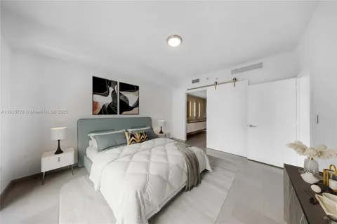 a bedroom with a bed and a night stand