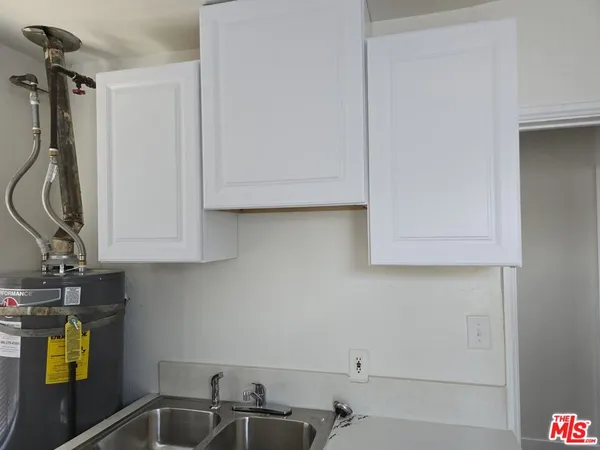 a bathroom with a sink and cabinets