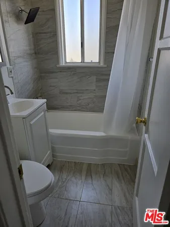 a bathroom with a toilet and a bathtub