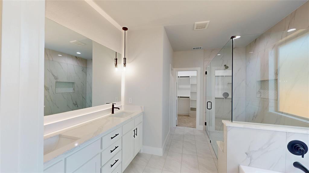 1609 Sharon Street Arlington, TX 76010 - Photo 18 of 29 a bathroom with a double vanity sink a mirror and a shower
