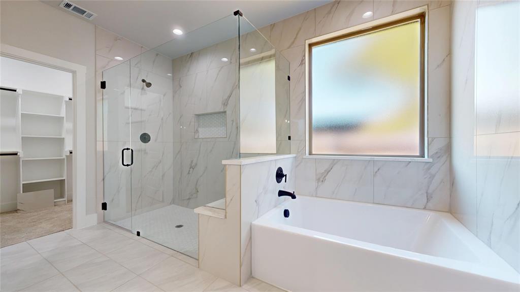 1609 Sharon Street Arlington, TX 76010 - Photo 19 of 29 a bathroom with a bathtub and a shower