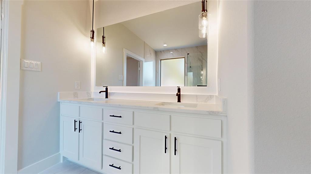 1609 Sharon Street Arlington, TX 76010 - Photo 20 of 29 a bathroom with double vanity sink and mirror