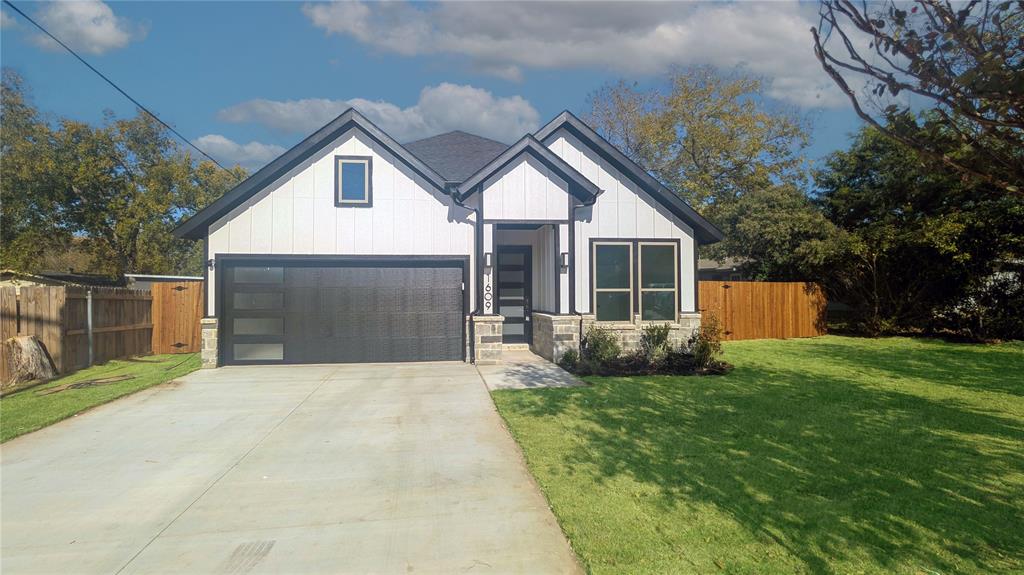 1609 Sharon Street Arlington, TX 76010 - Photo 2 of 29 a front view of a house with a yard and garage