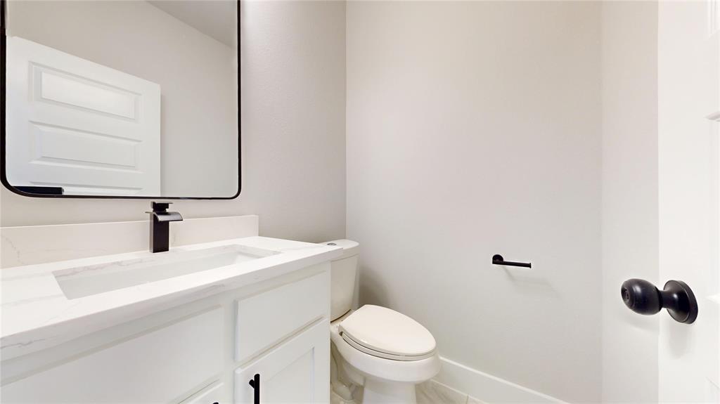 1609 Sharon Street Arlington, TX 76010 - Photo 22 of 29 a bathroom with a sink toilet and mirror
