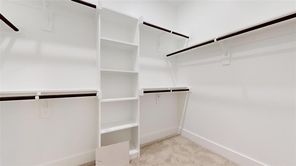 1609 Sharon Street Arlington, TX 76010 - Photo 25 of 29 a view of walk in closet with empty racks