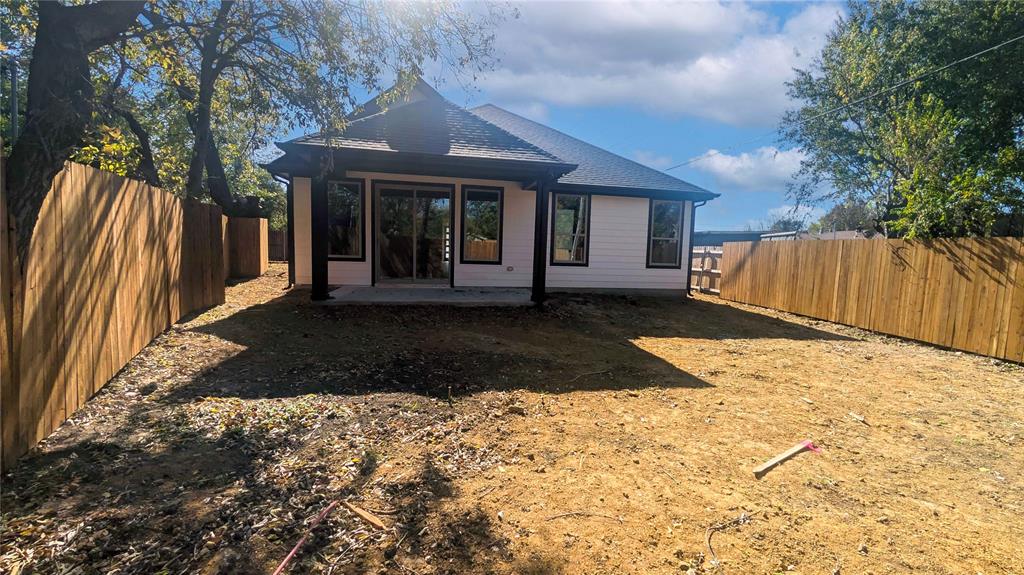 1609 Sharon Street Arlington, TX 76010 - Photo 28 of 29 a view of a house with a yard and wooden fence