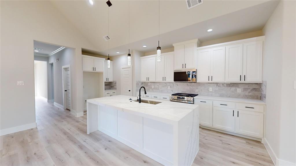 1609 Sharon Street Arlington, TX 76010 - Photo 6 of 29 a kitchen with stainless steel appliances granite countertop a sink stove and refrigerator