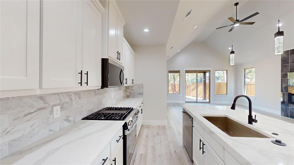 1609 Sharon Street Arlington, TX 76010 - Photo 8 of 29 a kitchen that has a sink a stove and a window