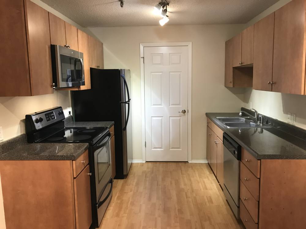 1350 Brook Street, Unit K St. Charles, IL 60174 - Photo 3 of 12 a kitchen with stainless steel appliances granite countertop a stove a sink and a refrigerator