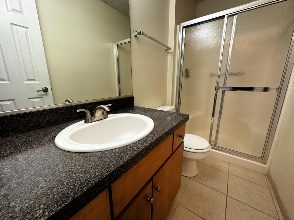 1350 Brook Street, Unit K St. Charles, IL 60174 - Photo 8 of 12 a bathroom with a sink a toilet and a mirror